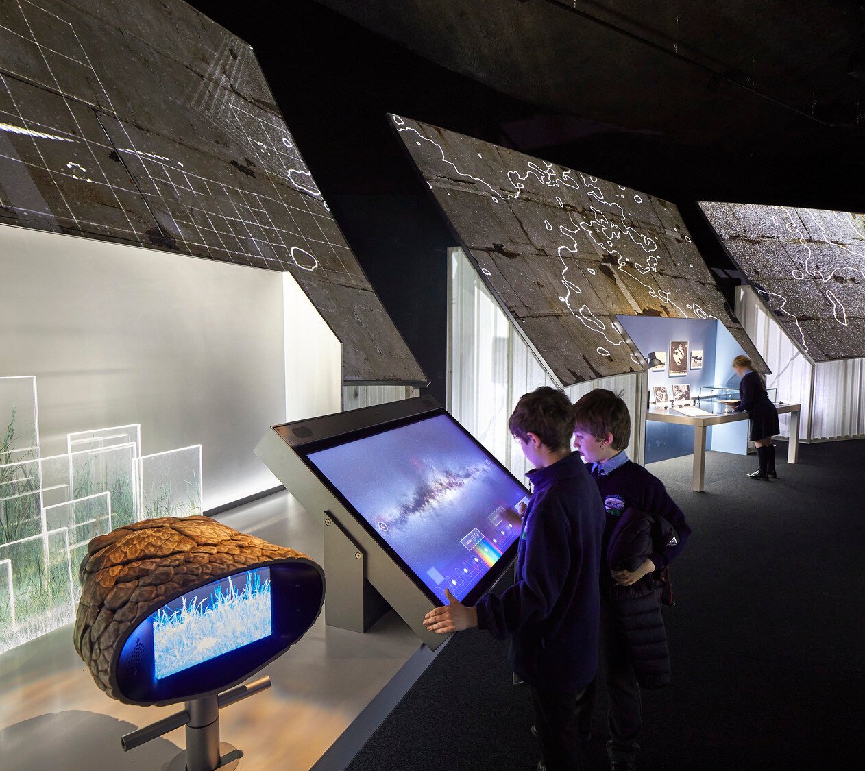 Definitive Guide to Interactive Displays - Two young visitors interacting with touchscreen