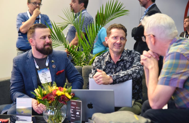 Tradeshow event attendees conducting a meeting in a common area