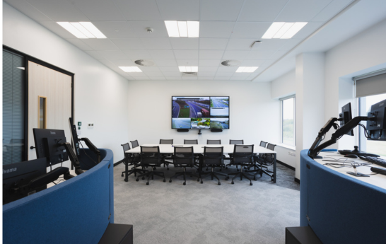 The conference room with a screen and a table with chairs taken from the back of the room