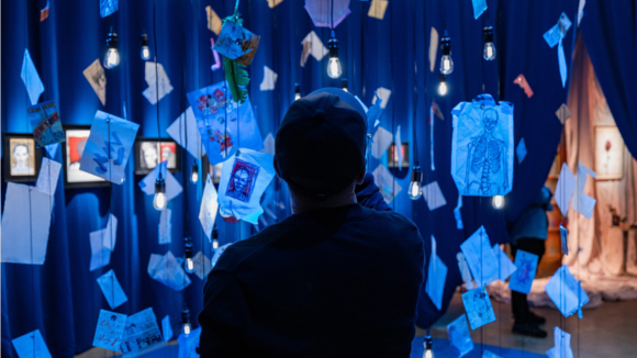 A person touching the relics hanging from the ceiling 