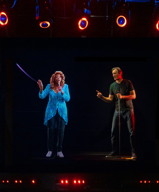 Visitors singing with projection through pepper ghost technology